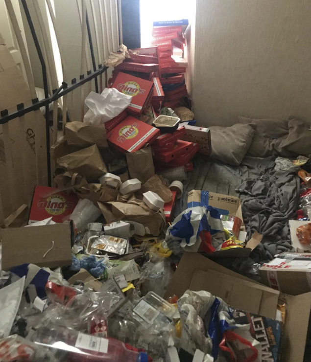 Hallway filled with takeaway boxes and rubbish — hoarding clearance required